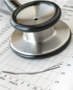 Stethoscope on newspaper financial chart